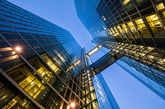 Low angle view of modern glass skyscrapers at blue hour