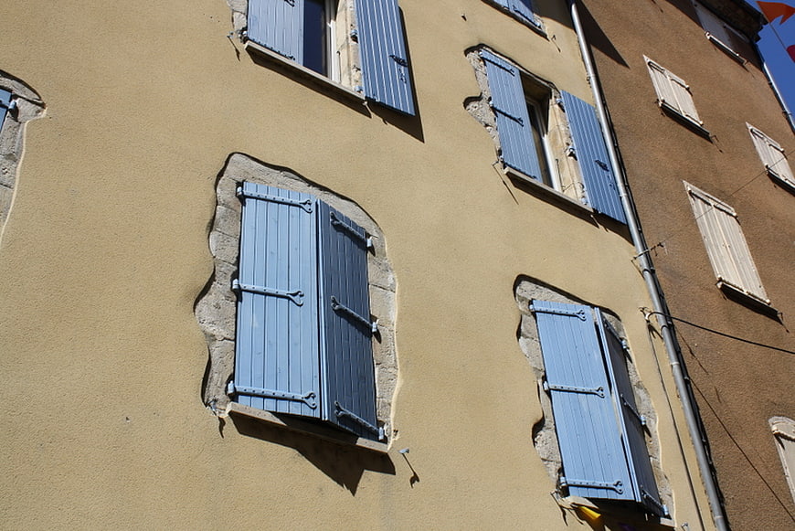 Blue Shutters on Yellow Stucco Wall in France