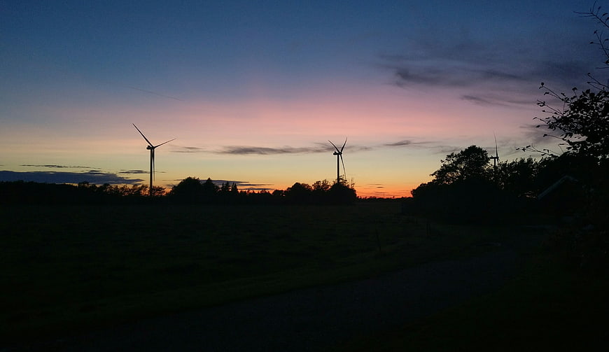 Silhouetted Wind Turbines Against a Colorful Sunset Sky