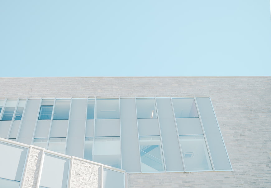 Modern White Brick Building with Blue Sky Background