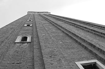 Low angle black and white view of brick tower architecture