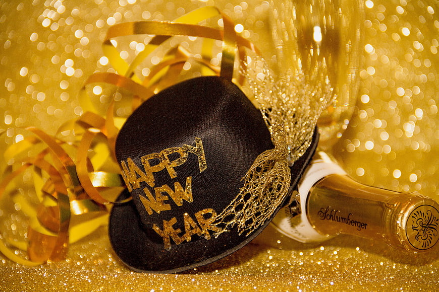Happy New Year celebration with champagne and party hat