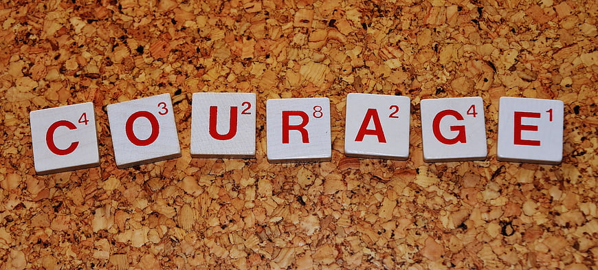 Scrabble Tiles Spelling Courage on Cork Board