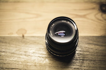 Black Camera Lens on Wooden Table