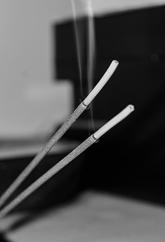 Black and white incense sticks with smoke