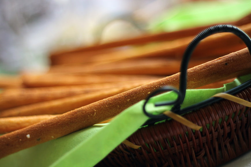 Close-up of crispy breadsticks in a wicker basket