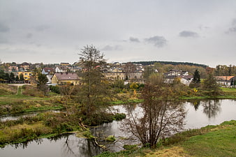 Serene River Landscape with Small Town in Autumn