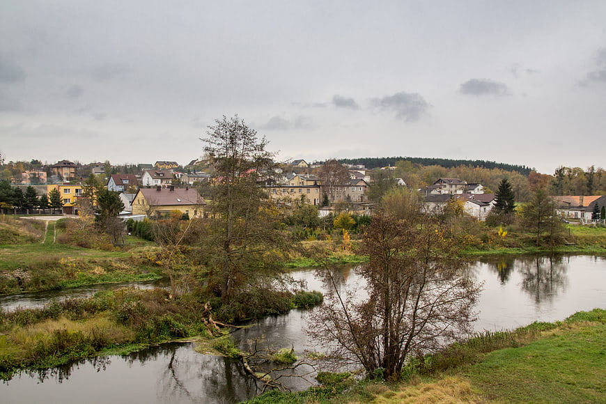 Serene River Landscape with Small Town in Autumn
