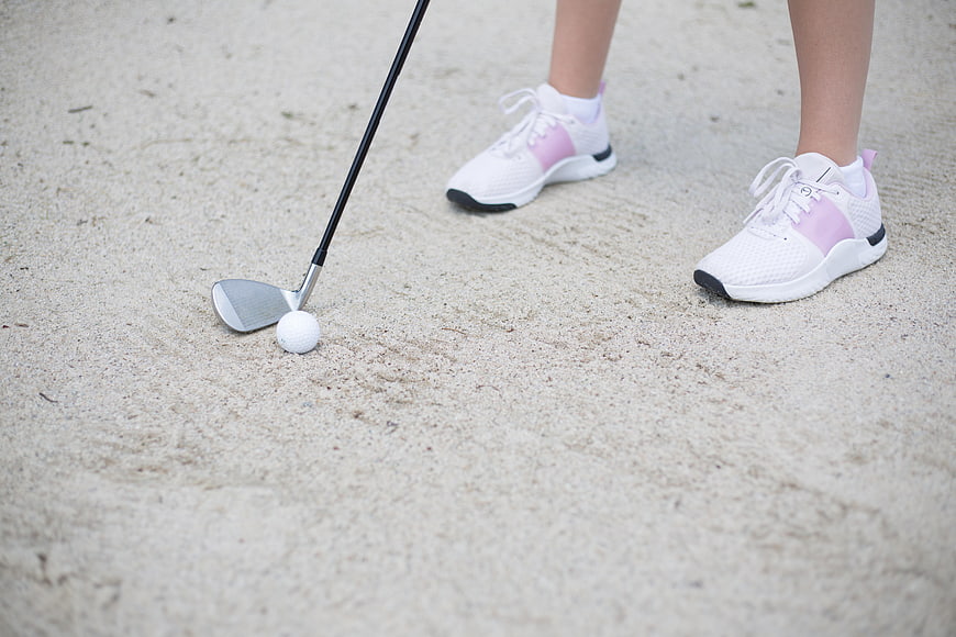 Golfer in Sand Trap with White and Pink Sneakers
