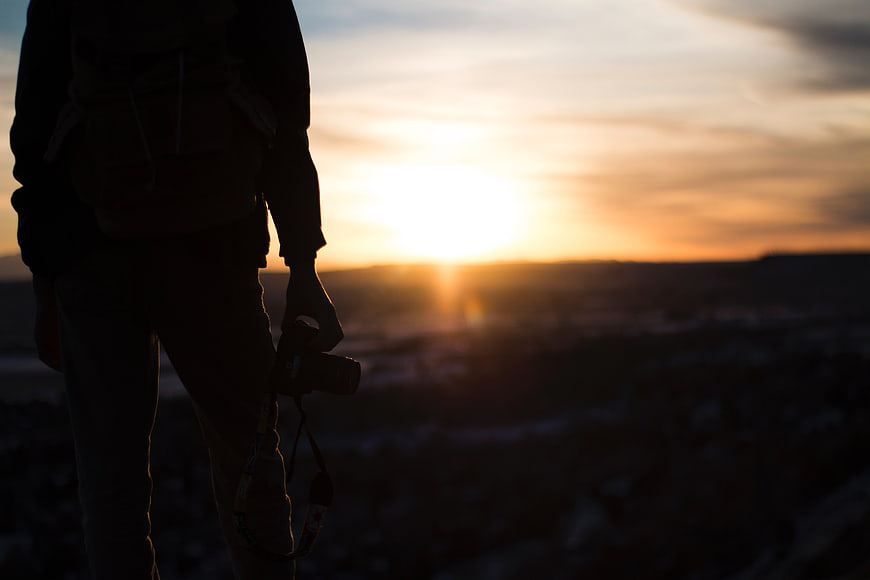 Silhouette of Photographer with Camera at Sunset