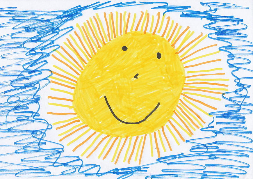 Child's drawing of a smiling sun with blue scribbles