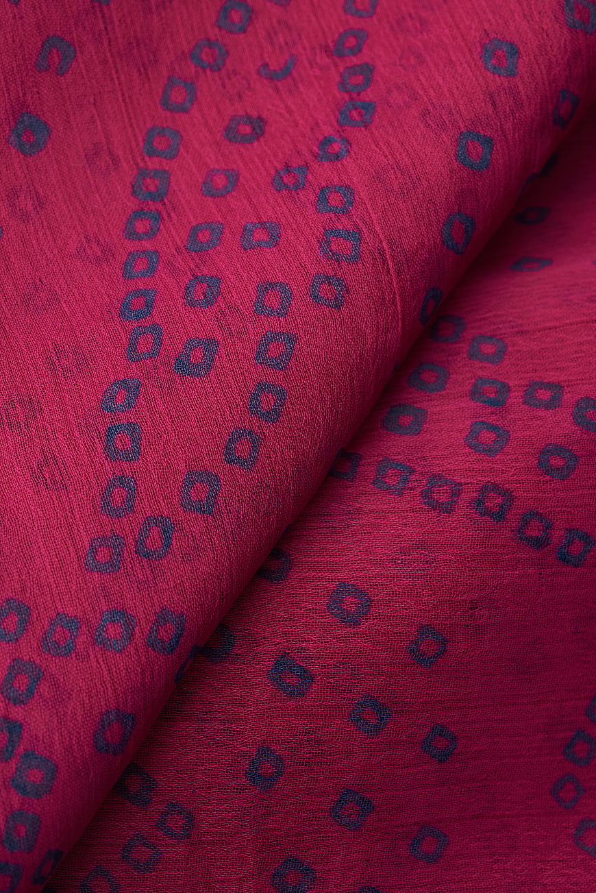 Close-up of red fabric with blue geometric pattern