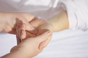 Close-up of hands receiving a gentle massage treatment