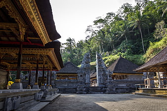 Traditional Balinese Temple Architecture with Stone Gate and Lush Jungle