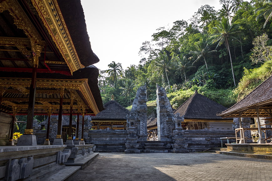 Traditional Balinese Temple Architecture with Stone Gate and Lush Jungle