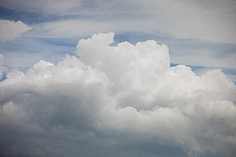 Dramatic White Cumulus Clouds Against Blue Sky