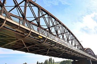 Low angle view of rusty steel truss bridge structure