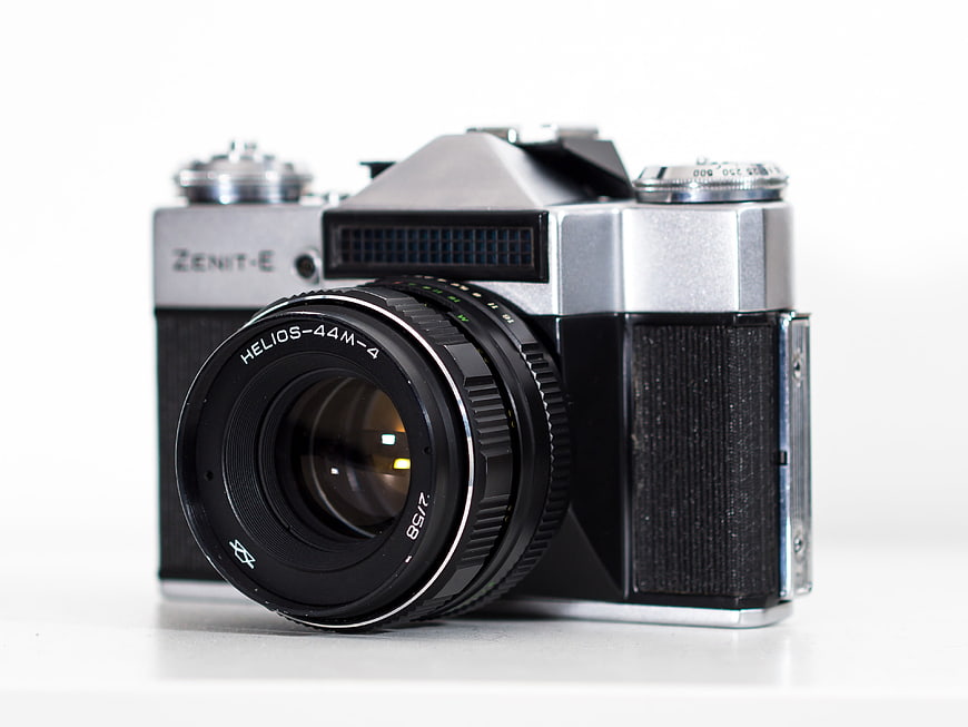Vintage Zenit-E Film Camera with Helios Lens on White Background
