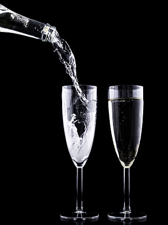Champagne Pouring into Flutes on Black Background