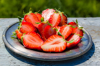 Fresh Sliced Strawberries on Silver Plate Outdoors
