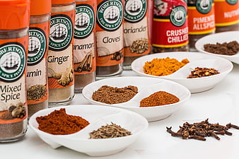 Assortment of Robertson's spice jars and bowls of ground spices