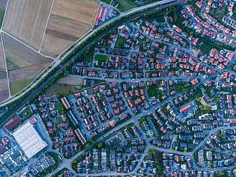 Aerial View of Suburban Neighborhood with Red Roofs and Fields