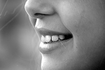 Close-up of smiling lips and teeth in black and white
