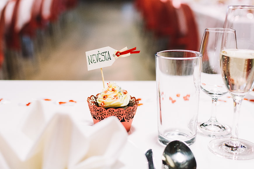 Wedding table setting with bride's cupcake and champagne