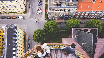 Aerial view of couple on spiral staircase overlooking city