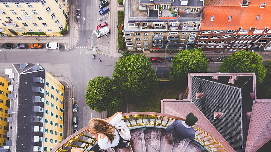 Aerial view of couple on spiral staircase overlooking city