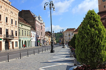 Colorful historic European street with cobblestone pavement and architecture