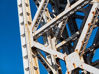 White Steel Bridge Truss Structure Against Blue Sky