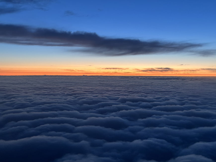 Aerial View of Sea of Clouds at Sunset Horizon