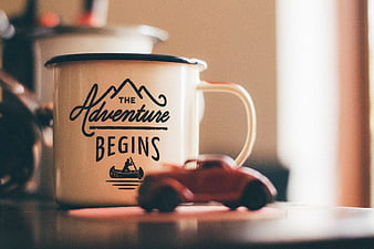 Enamel mug with adventure quote and toy car