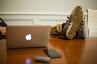 Relaxed worker with feet on desk and laptop