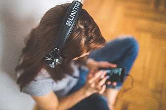 Woman listening to music on smartphone with headphones