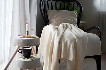 Cozy Hygge Interior With Candle, Coffee, And Cream Throw Blanket