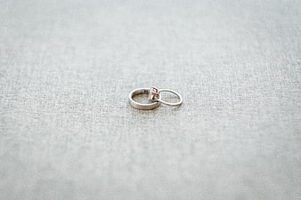 Silver Wedding Rings on Textured Fabric Background