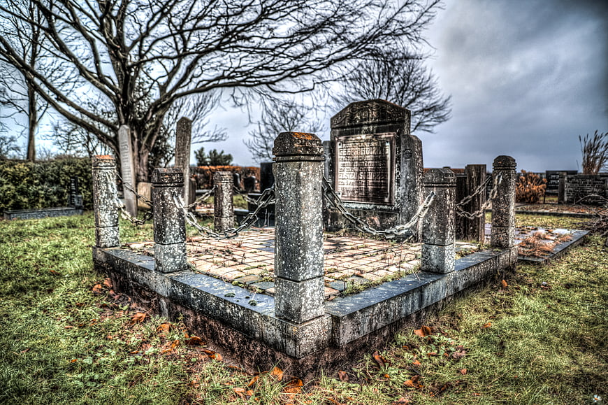 Old stone grave with chains in a cemetery