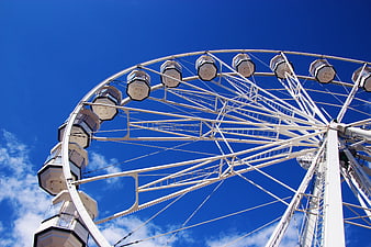 White Ferris Wheel Against Blue Sky