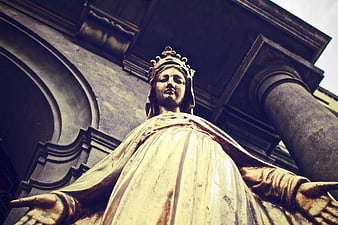 Low angle view of golden religious statue with crown