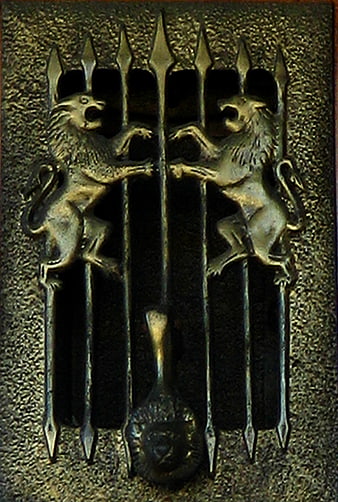 Vintage brass lion grating with decorative spikes
