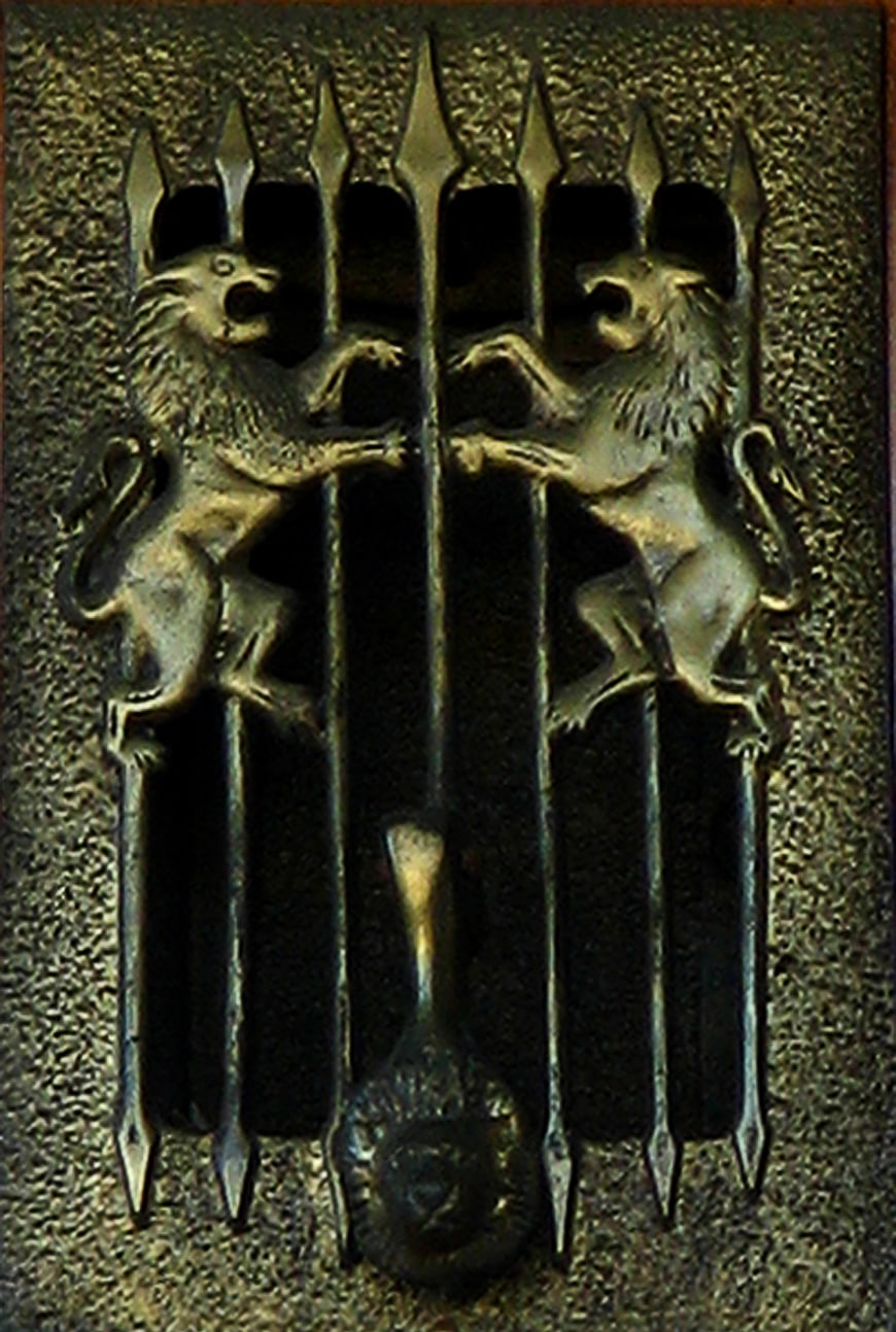 Vintage brass lion grating with decorative spikes