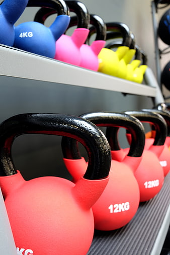 Colorful Kettlebells on Gym Rack for Fitness Training