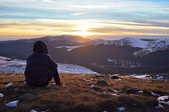 Man in Hoodie Watching Mountain Sunset