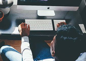 Overhead view of man working on computer at desk
