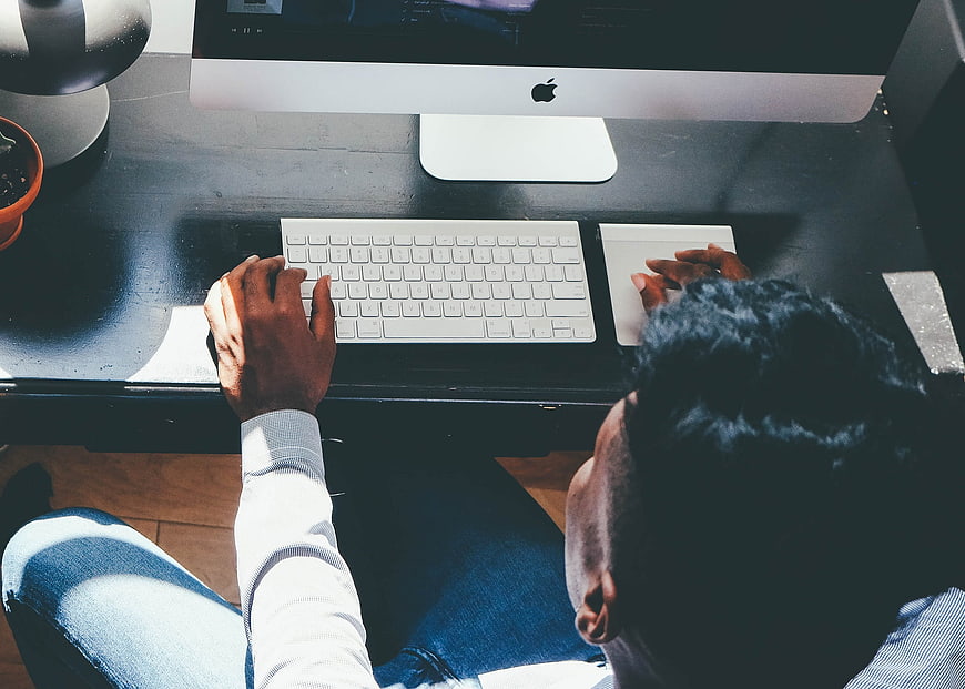 Overhead view of man working on computer at desk
