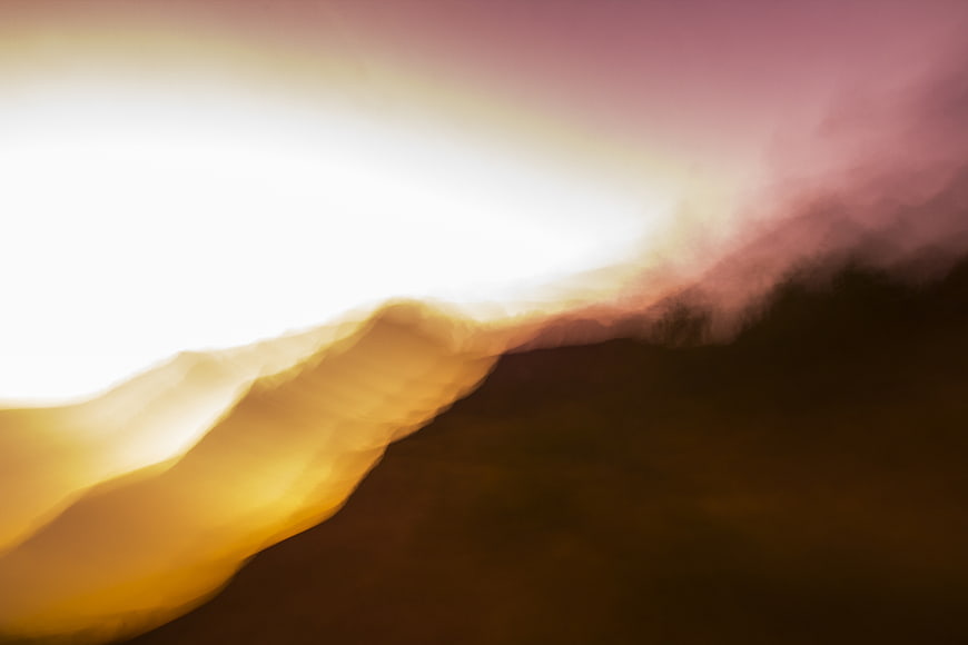 Abstract motion blur landscape with golden and purple hues