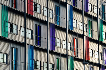 Modern apartment facade with colorful vertical window panels
