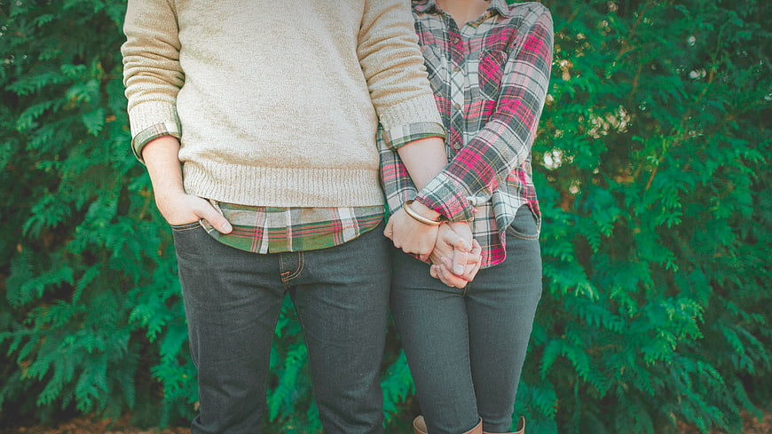 Couple Holding Hands in Plaid and Sweater Outdoors